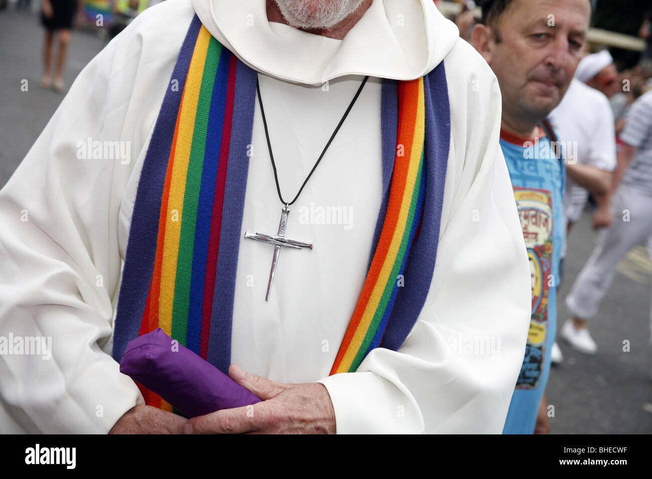 Rainbow stole and cross on a priest at Brighton and Hove Gay Pride