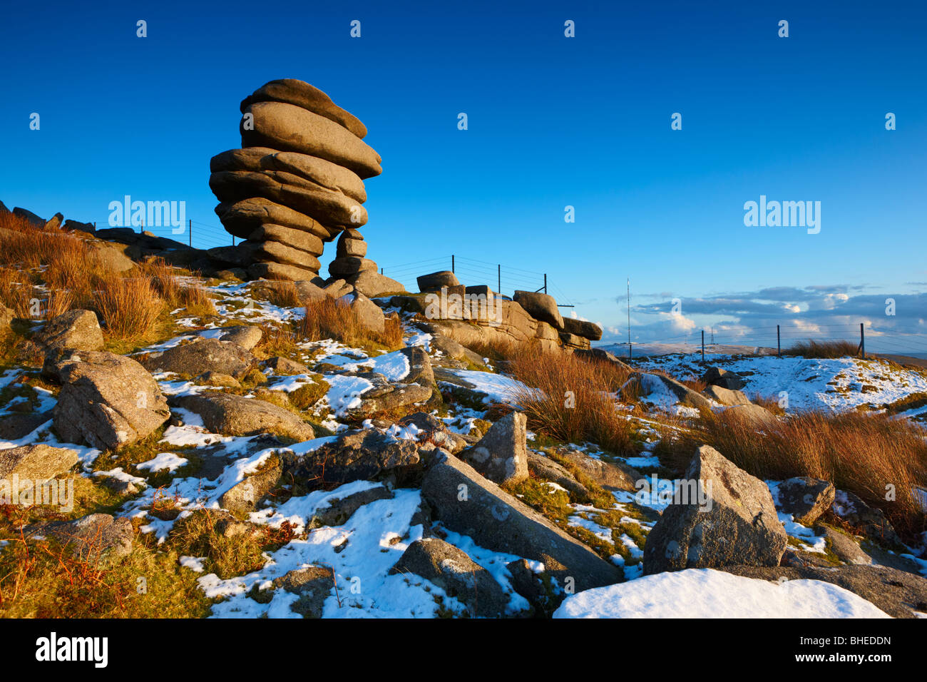 The rock formation know as the Cheesewrings stands high up on Bodmin Moor after snowfall Stock Photo