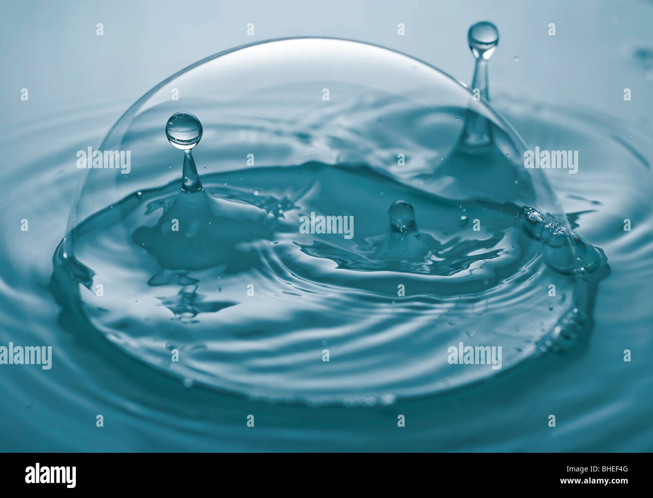 the splashing water drop inside of a soap bubble Stock Photo - Alamy