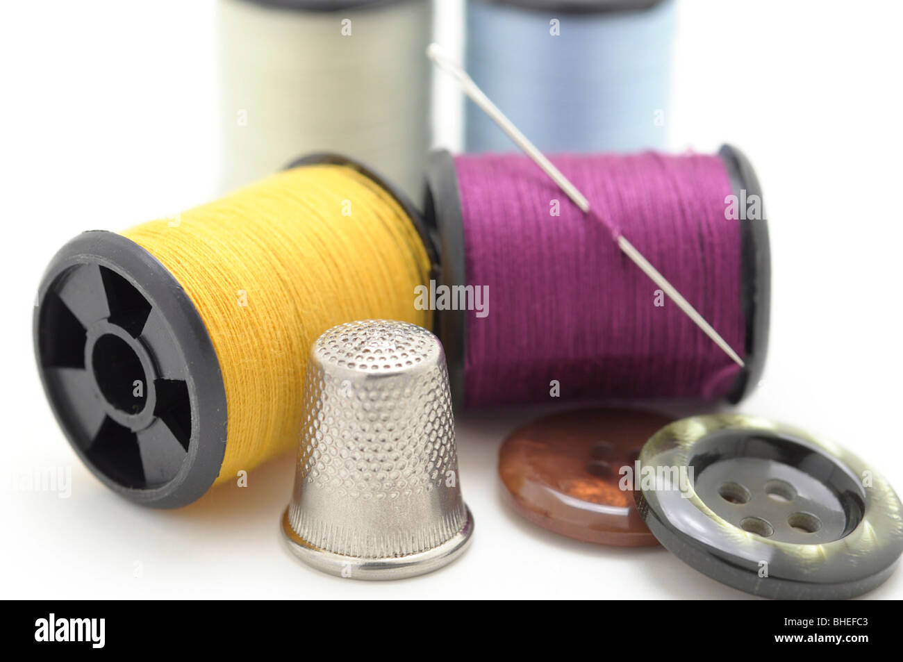 Spools of thread and Needle, Thimble and Buttons Stock Photo