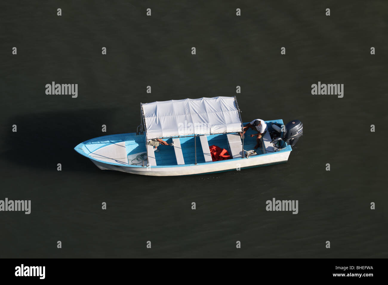 Water taxi and tourist boat in ocean at Puerto Vallarta, Mexico. Top view. White and blue boat