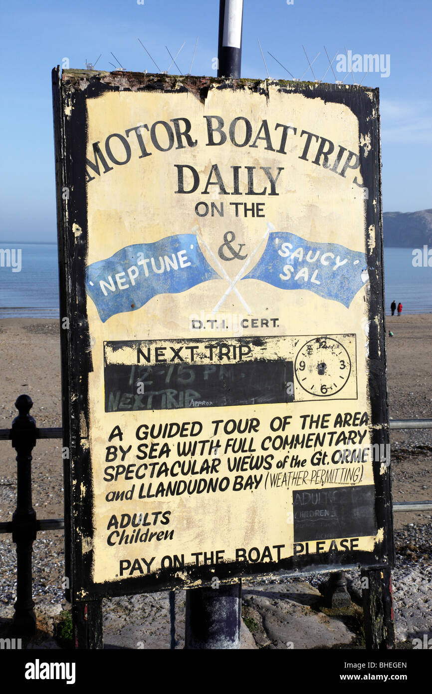 sign advertising boat trips for tourists around the bay from the parade llandudno conway clwyd north wales uk Stock Photo