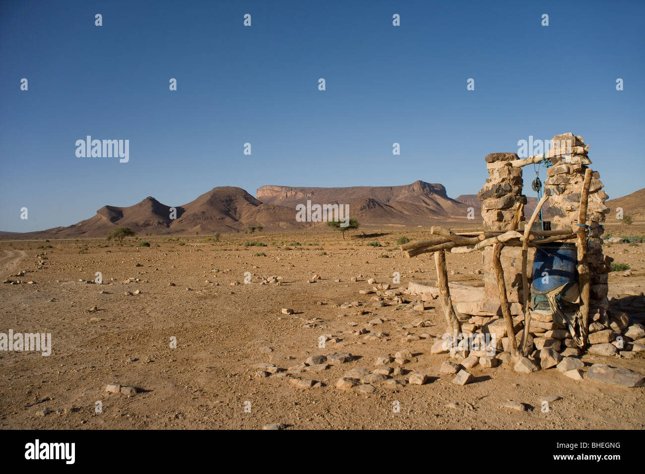 Well in the Sahara Desert with Flat top mountains in the distance in