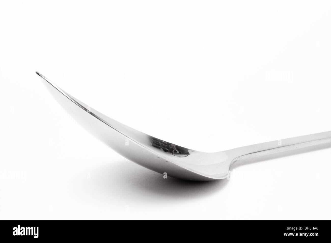 Large Stainless steel Kitchen spoon isolated against white background. Stock Photo
