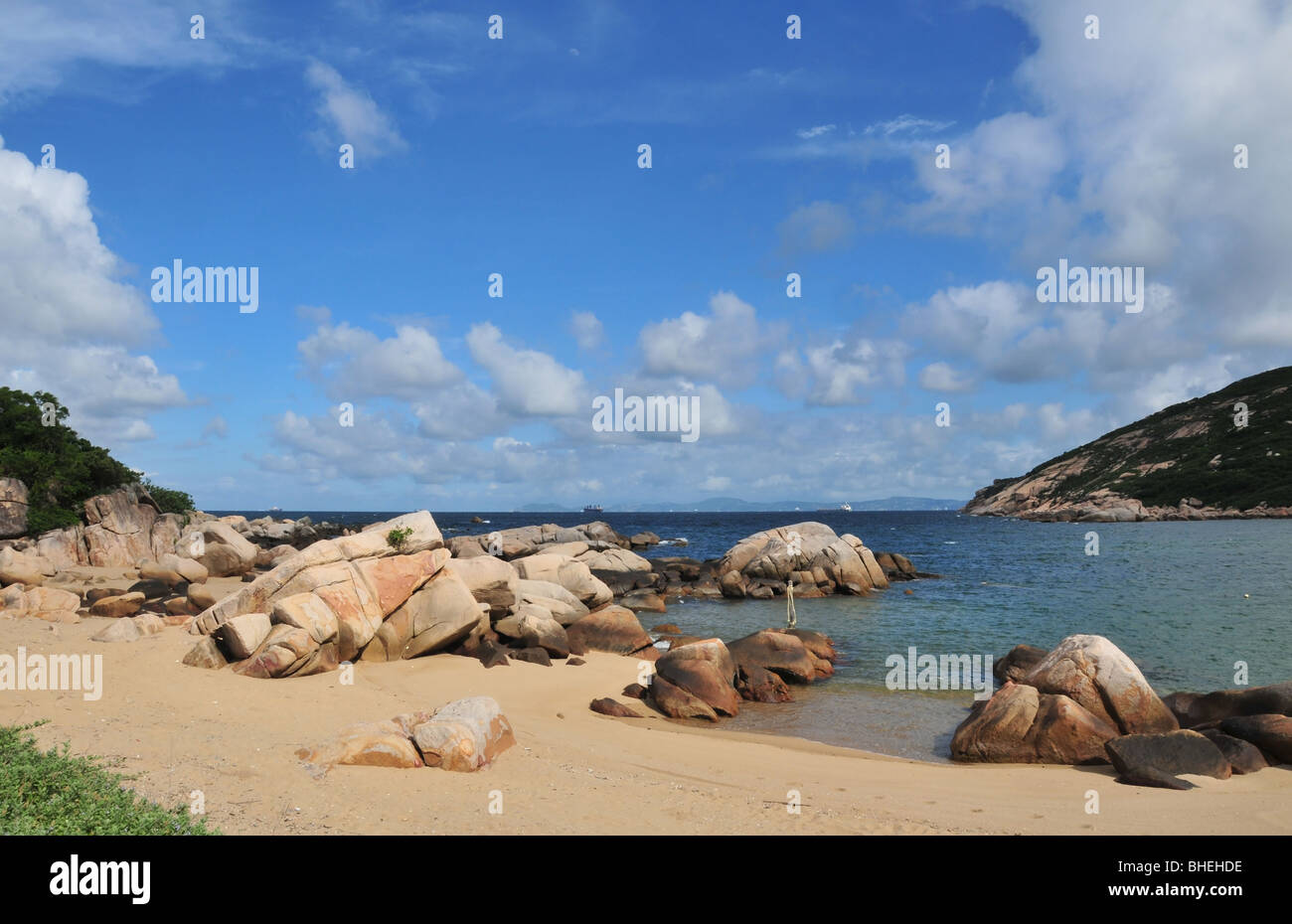 Blue sky, blue sea, granite rocks beach view, in a bay at the edge of the South China Sea, near Tun O, Lamma Island, Hong Kong Stock Photo