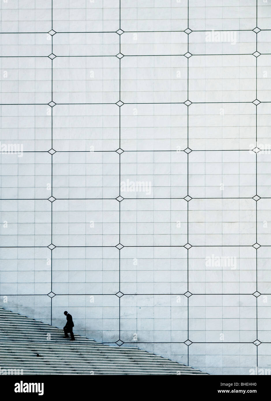 Lone business man on the steps of the Grand Arche, La Defence, Paris Stock Photo