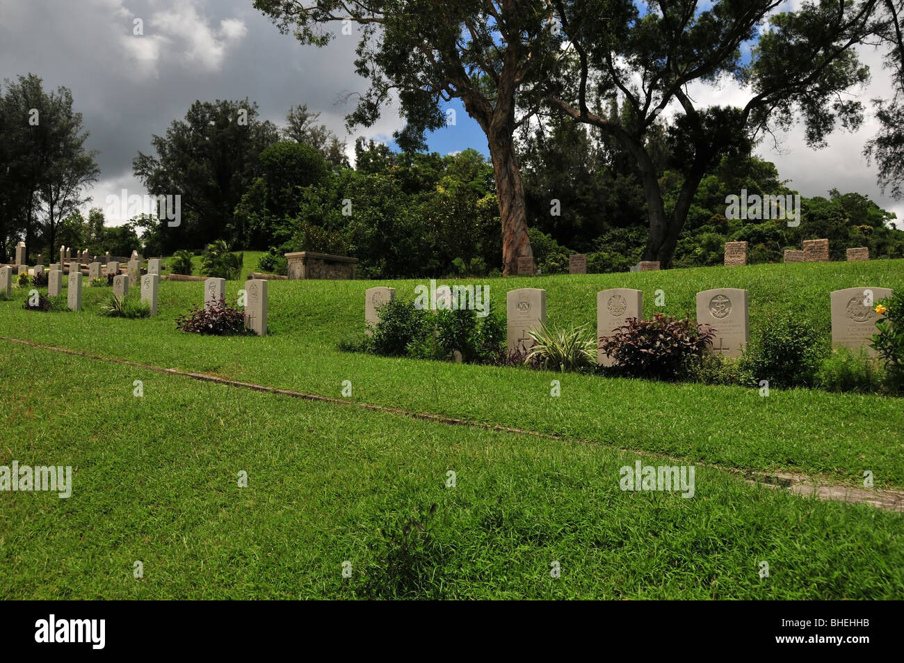 Grassy slope with a line of early 1940s military grave headstones, Stanley Military Cemetery, Stanley, Hong Kong, China Stock Photo