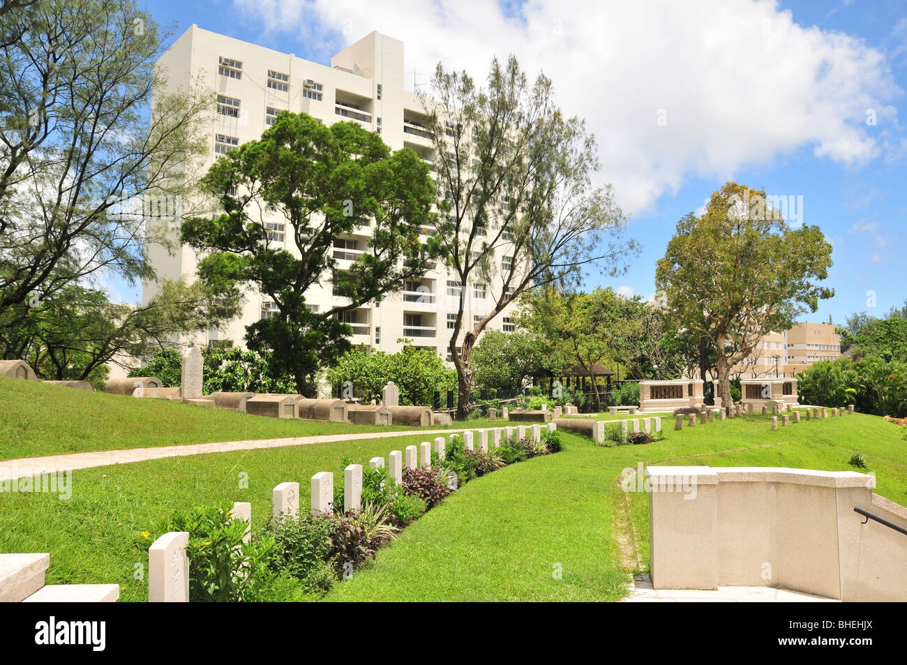 A line of 1940s headstones, in front of older graves, in the garden landscape of Stanley Military Cemetery, Hong Kong, China Stock Photo
