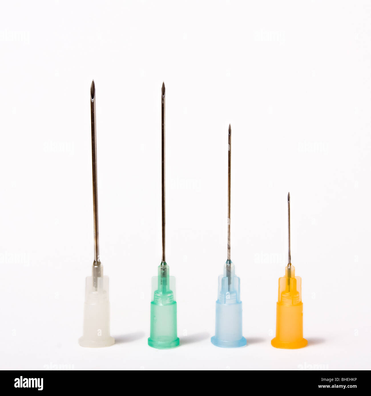 A line of different sized colour coded Hypodermic needles isolated