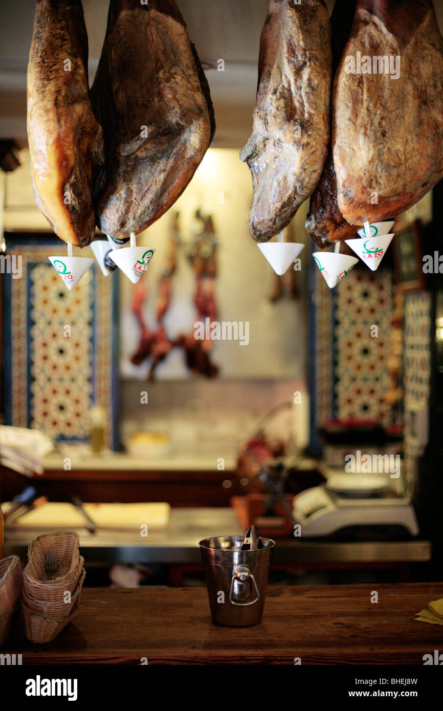 'Jamon Iberico' - Iberian Ham from Acorn fed pigs hanging in a cafe in Seville, Spain. Stock Photo