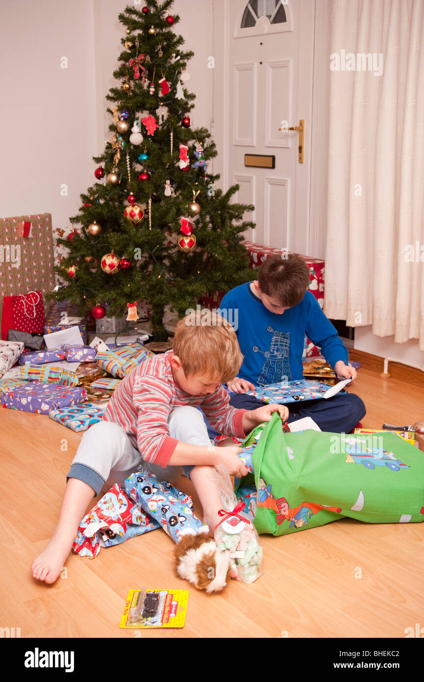 Children kid kids boys unwrapping presents under the christmas tree hi