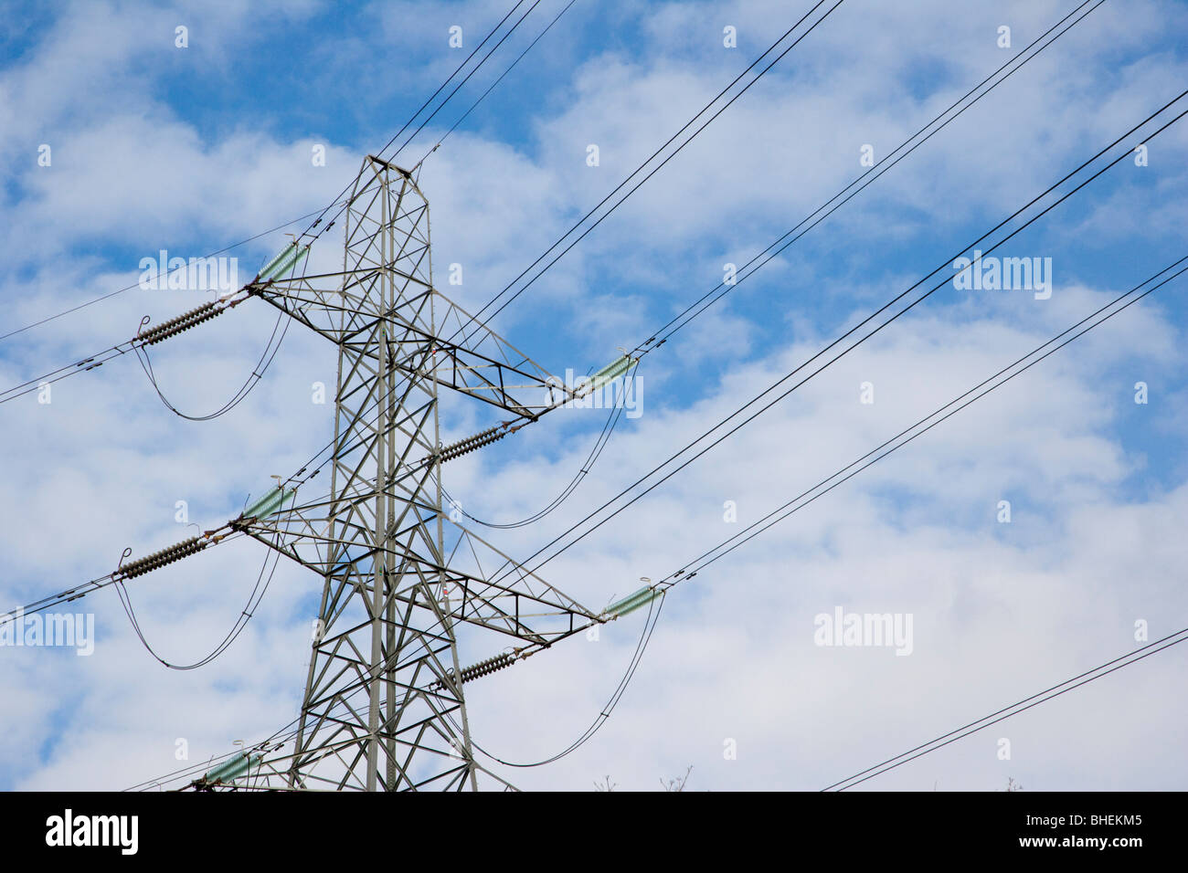 High voltage power lines, electrical tower against blue sky Stock Photo ...