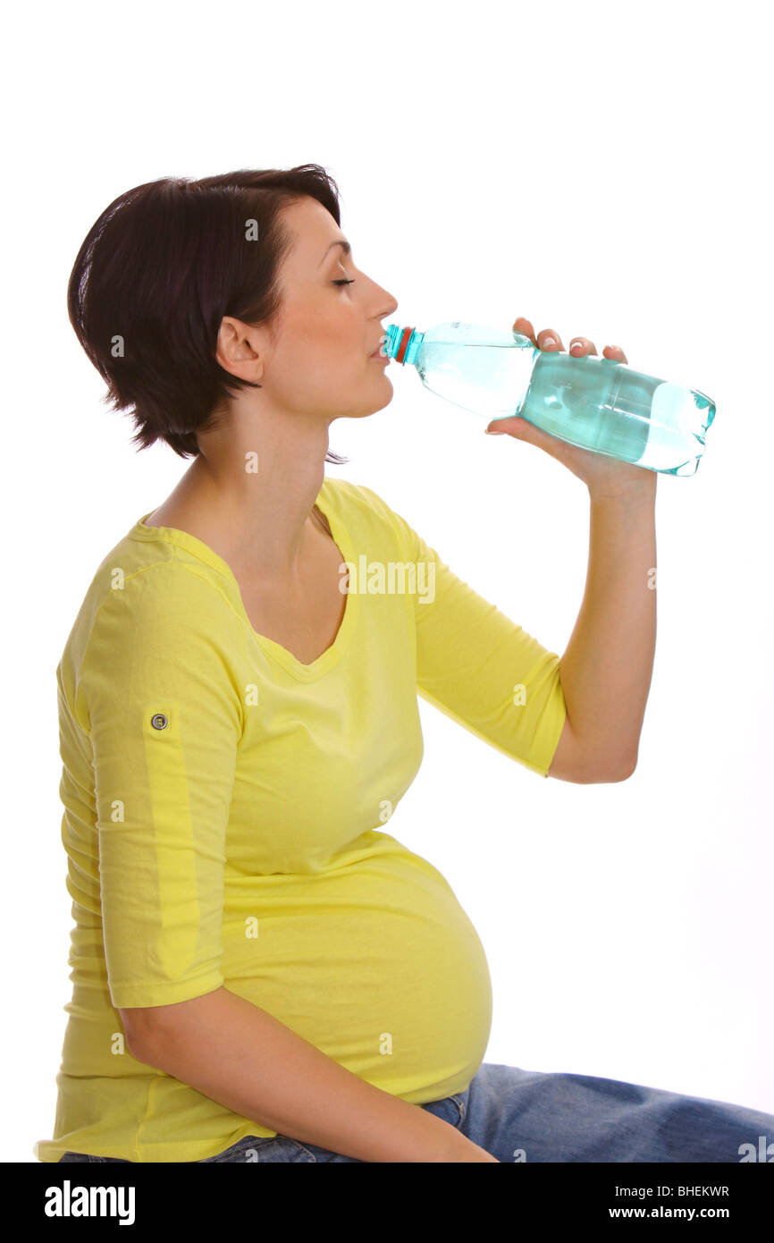 Pregnant woman drinking mineral water from a bottle Stock Photo Alamy