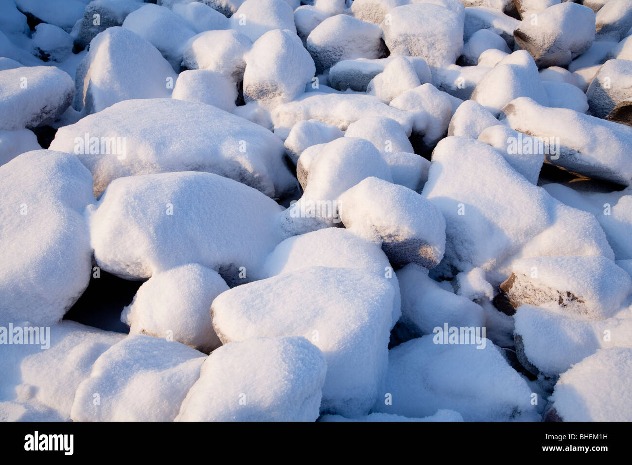 Snow covered stones Stock Photo Alamy