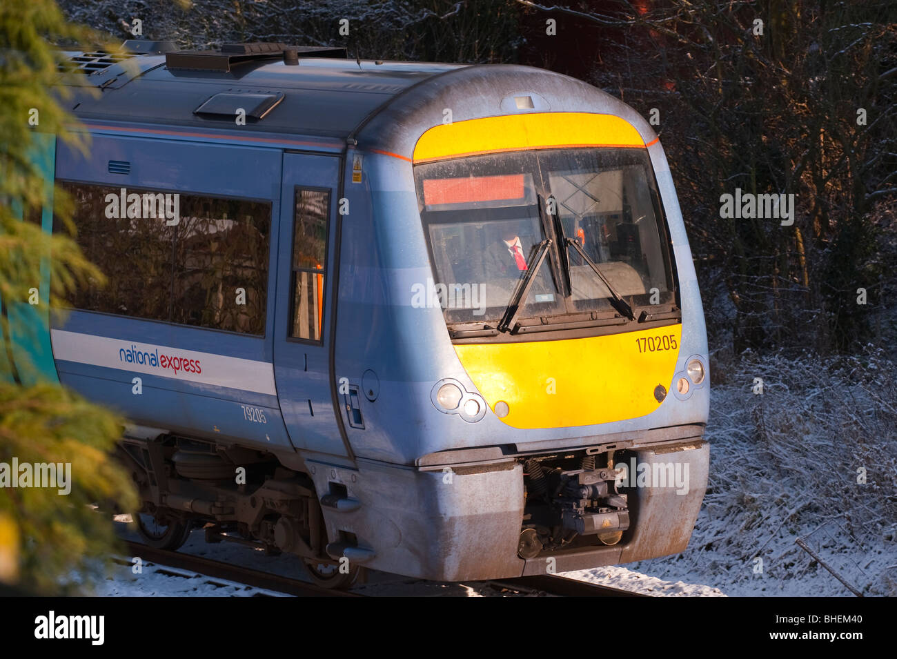 A National Express diesel locomotive train on the Suffolk line in the snow in the Uk Stock Photo