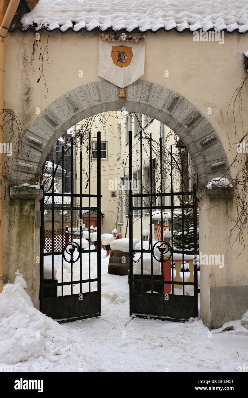 Entrance gates in snow covered street in the Old Town, Tallinn, Estonia. Stock Photo