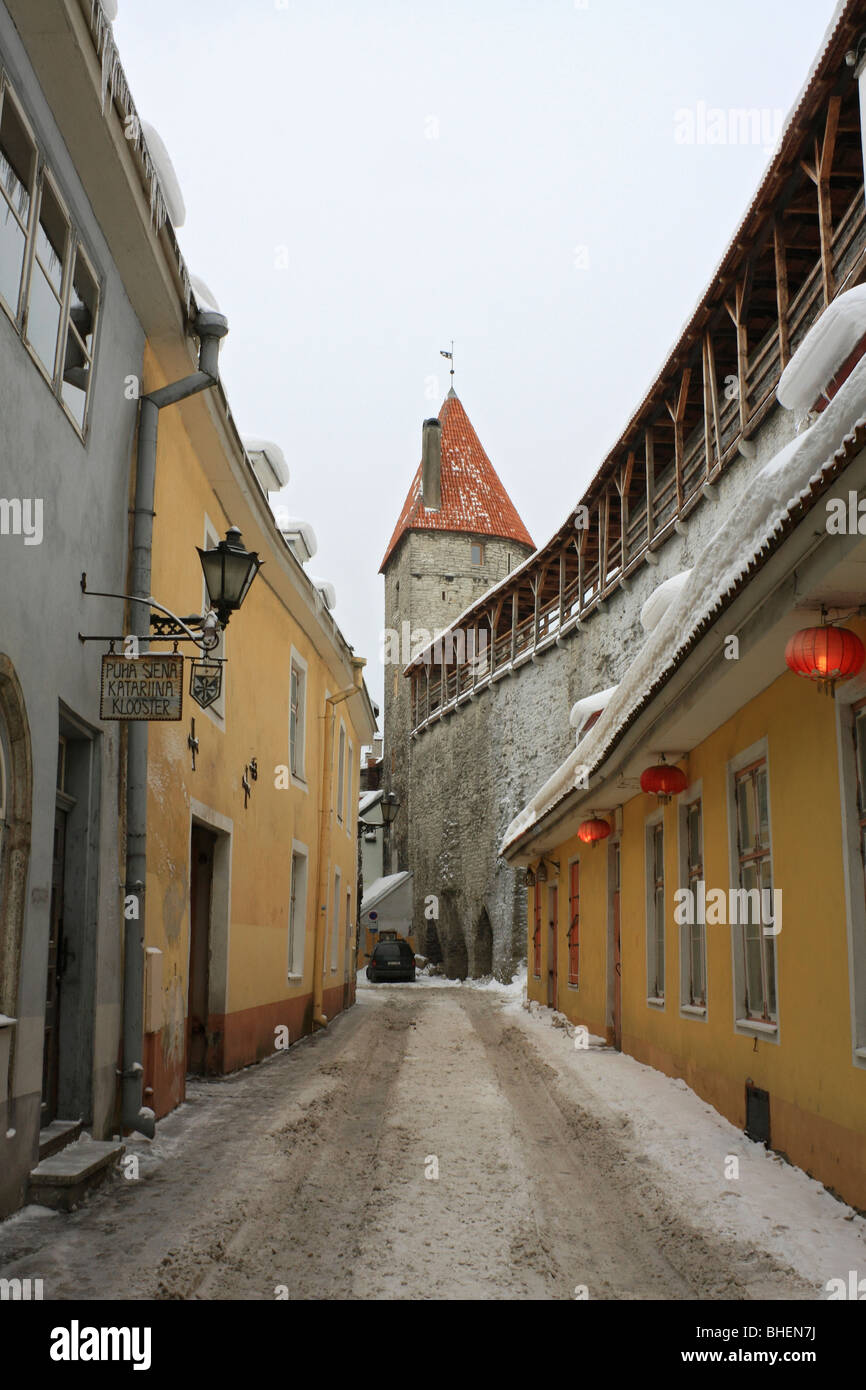 Part of the stone wall and Snow covered Muurivahe street in the Old Town, Tallinn, Estonia. Stock Photo