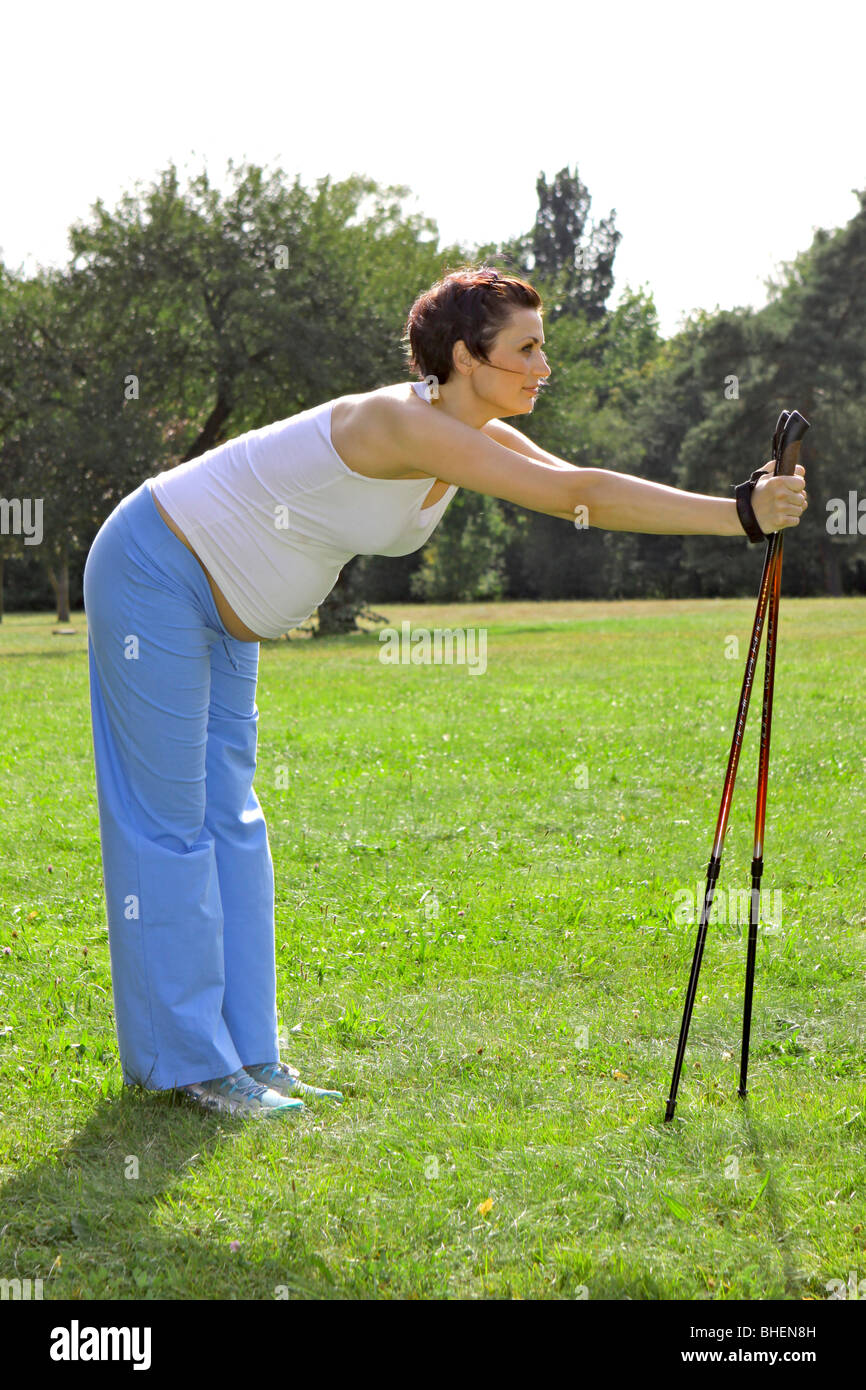 a pregnant woman during Nordic Walking, Schwangere Frau beim Nordic Walking Stock Photo