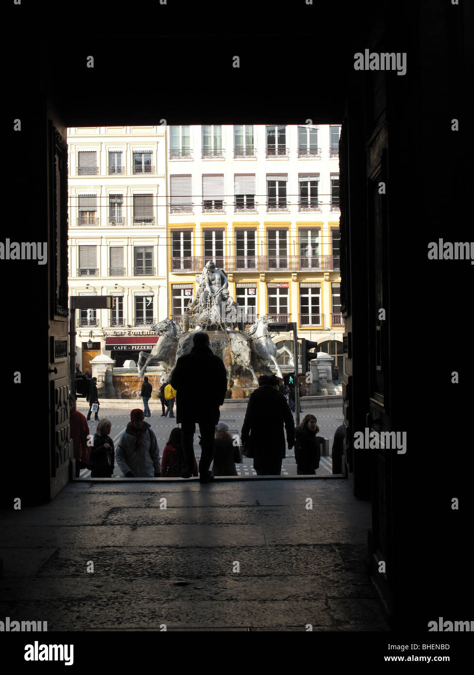silhouette of visitors at the door of Musee des Beaux-arts - Bartholdi fountain in the distance - place des terreaux - Lyon - Fr Stock Photo