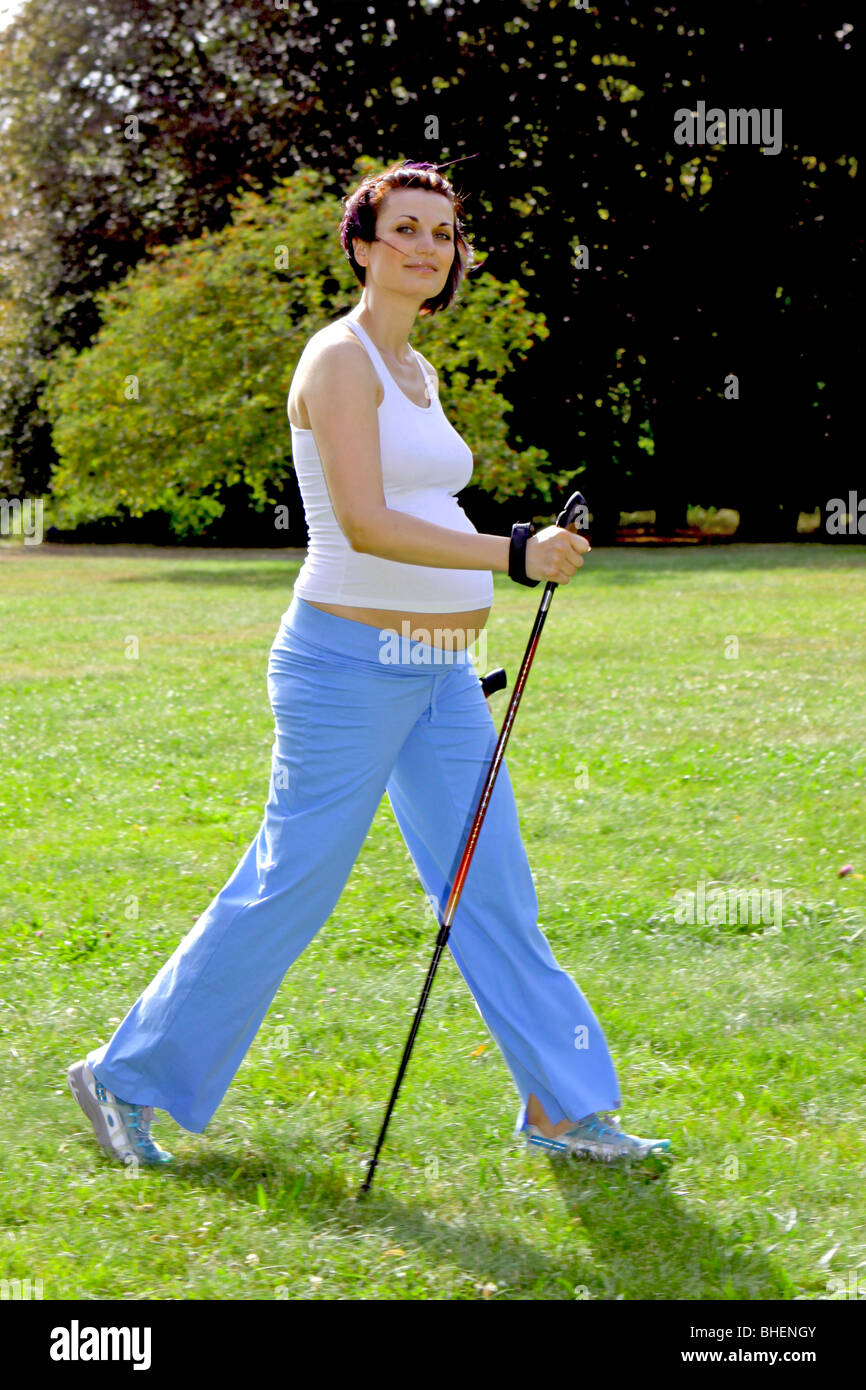 a pregnant woman during Nordic Walking, Schwangere Frau beim Nordic Walking Stock Photo