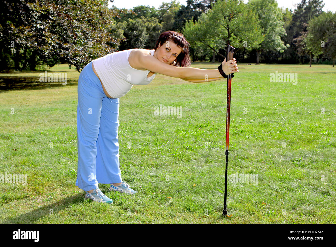 a pregnant woman during Nordic Walking, Schwangere Frau beim Nordic Walking Stock Photo