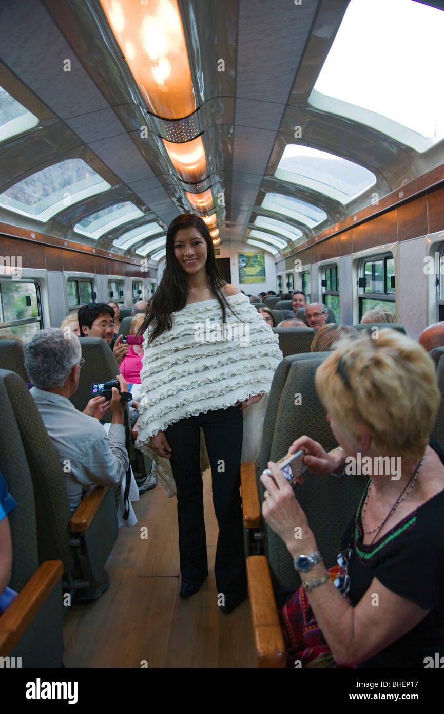 Train staff entertaining passengers with a fashion show on the journey