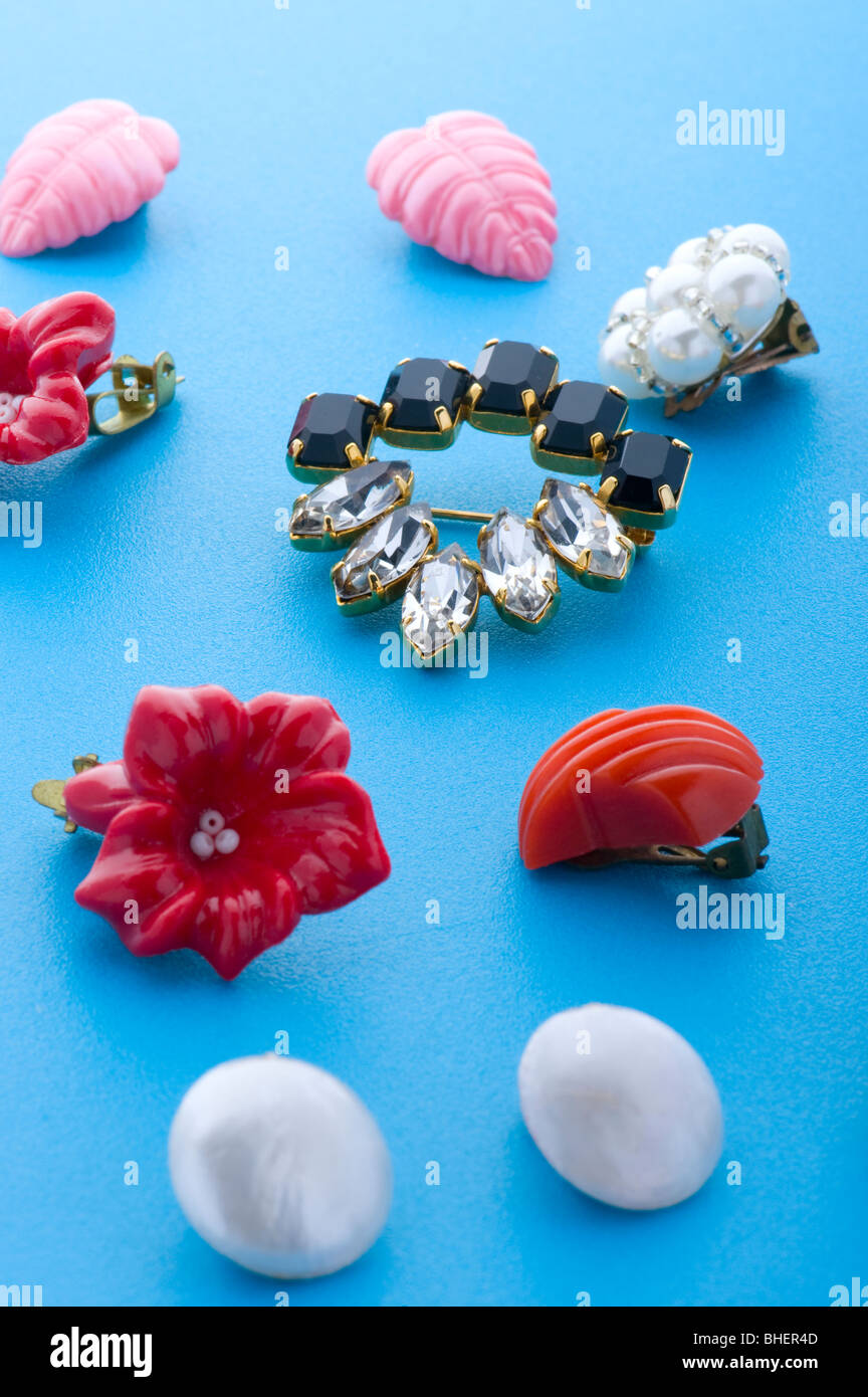 object on blue - costume jewel brooch and earring Stock Photo