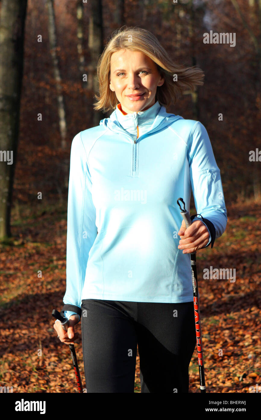 woman doing nordic walking, blonde Frau beim Nordic Walking Stock Photo ...