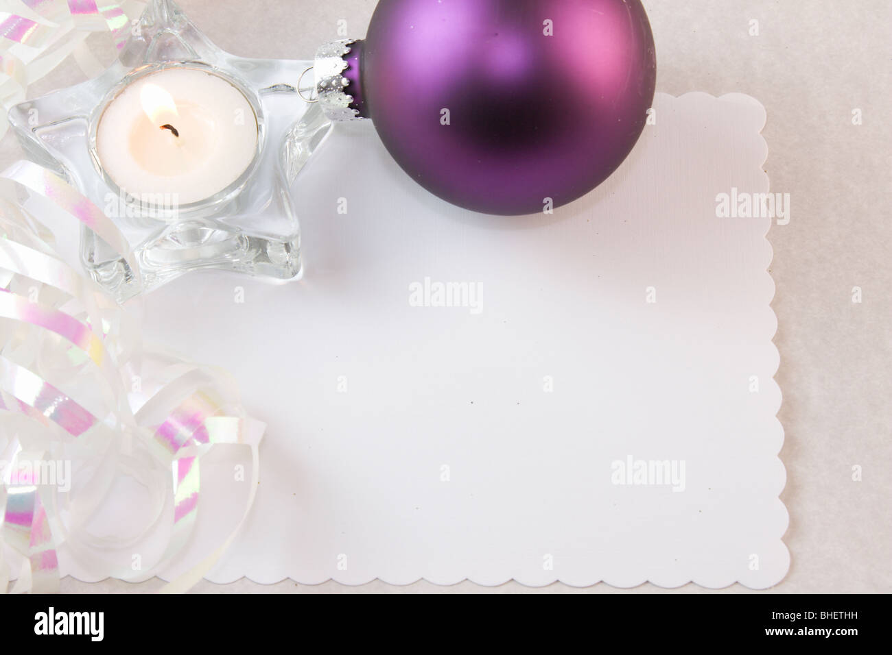 purple Christmas bauble, white metallic ribbon and copy space Stock Photo
