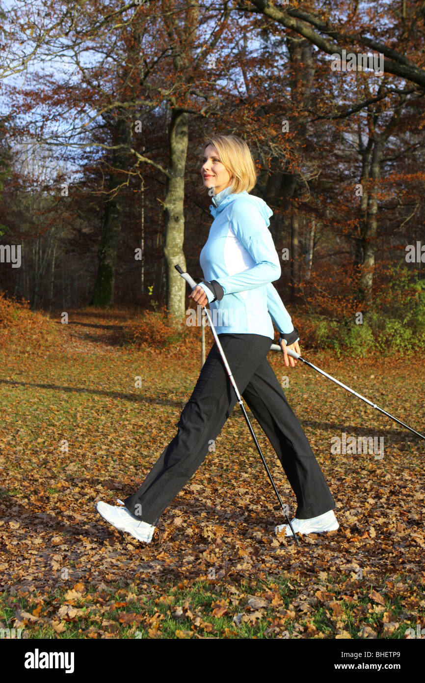 woman doing nordic walking, blonde Frau beim Nordic Walking Stock Photo ...