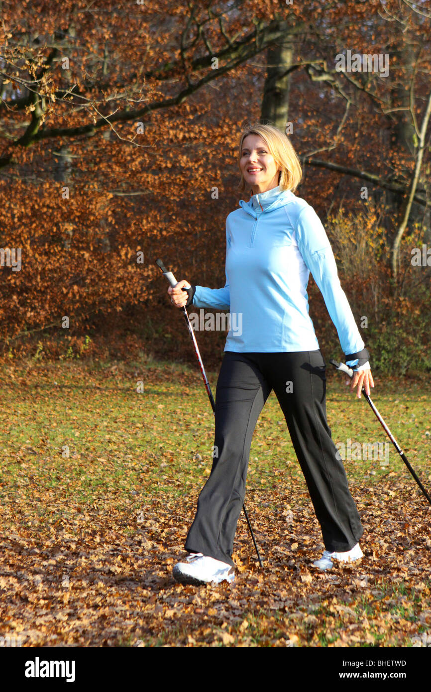 woman doing nordic walking, blonde Frau beim Nordic Walking Stock Photo ...