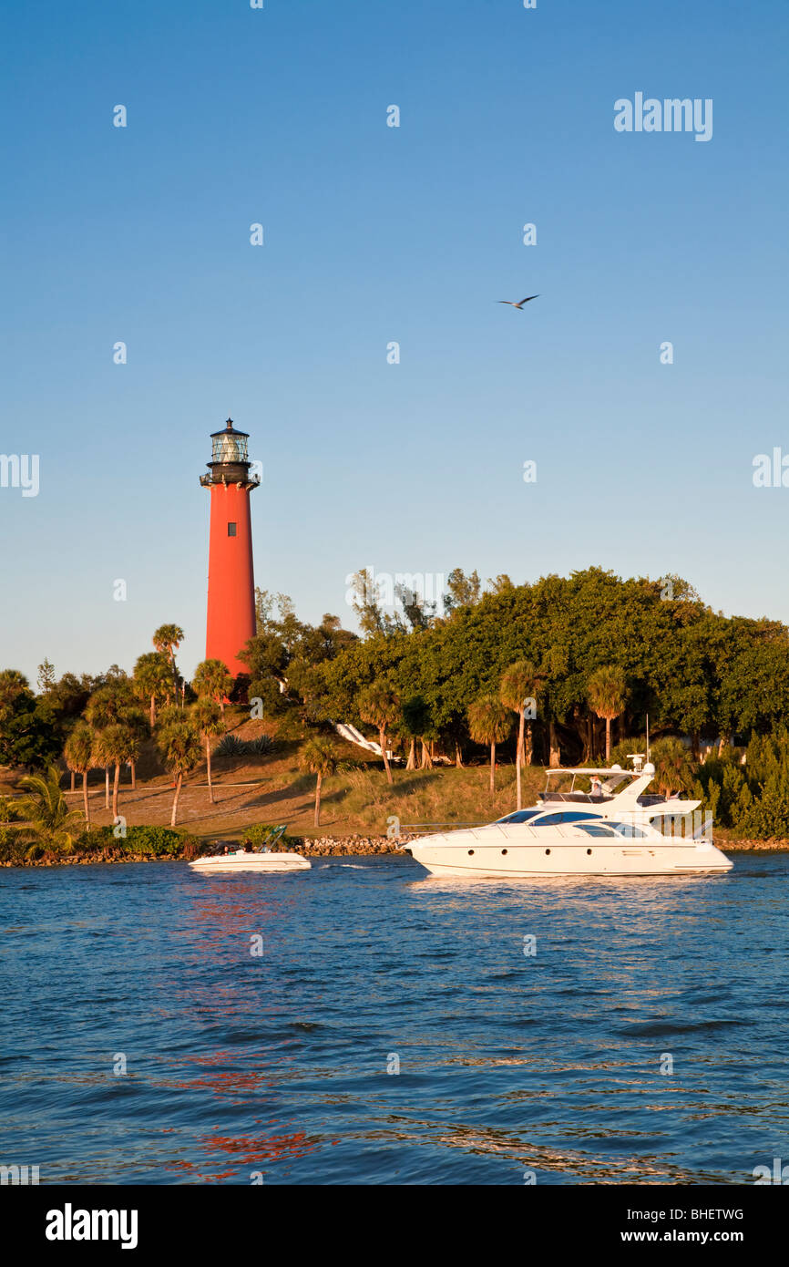 Private yacht and pleasure boat pass Jupiter Inlet Light lighthouse in