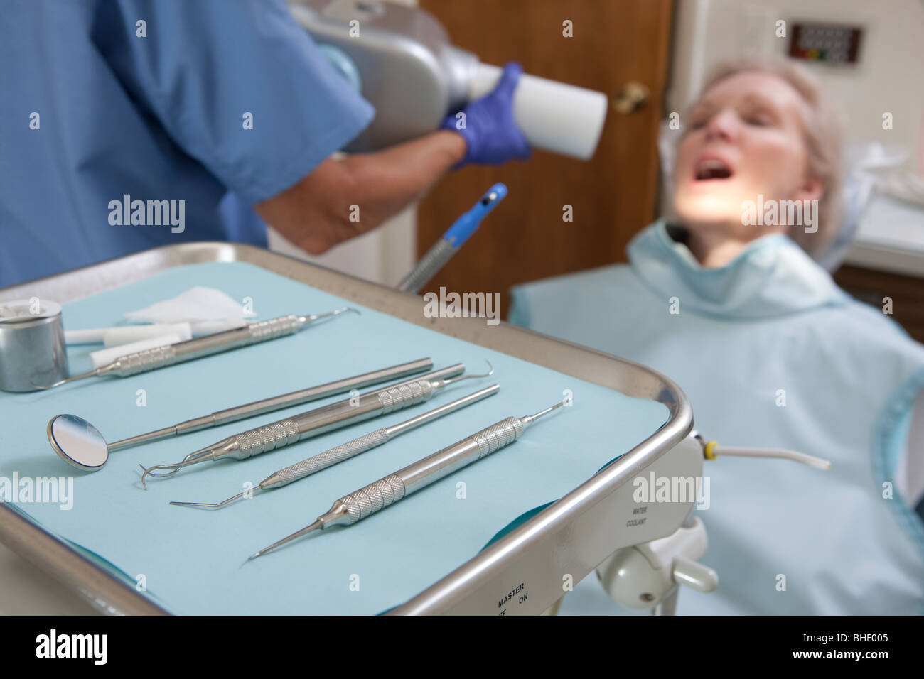 Dental equipment with a female dentist examining a patient Stock Photo