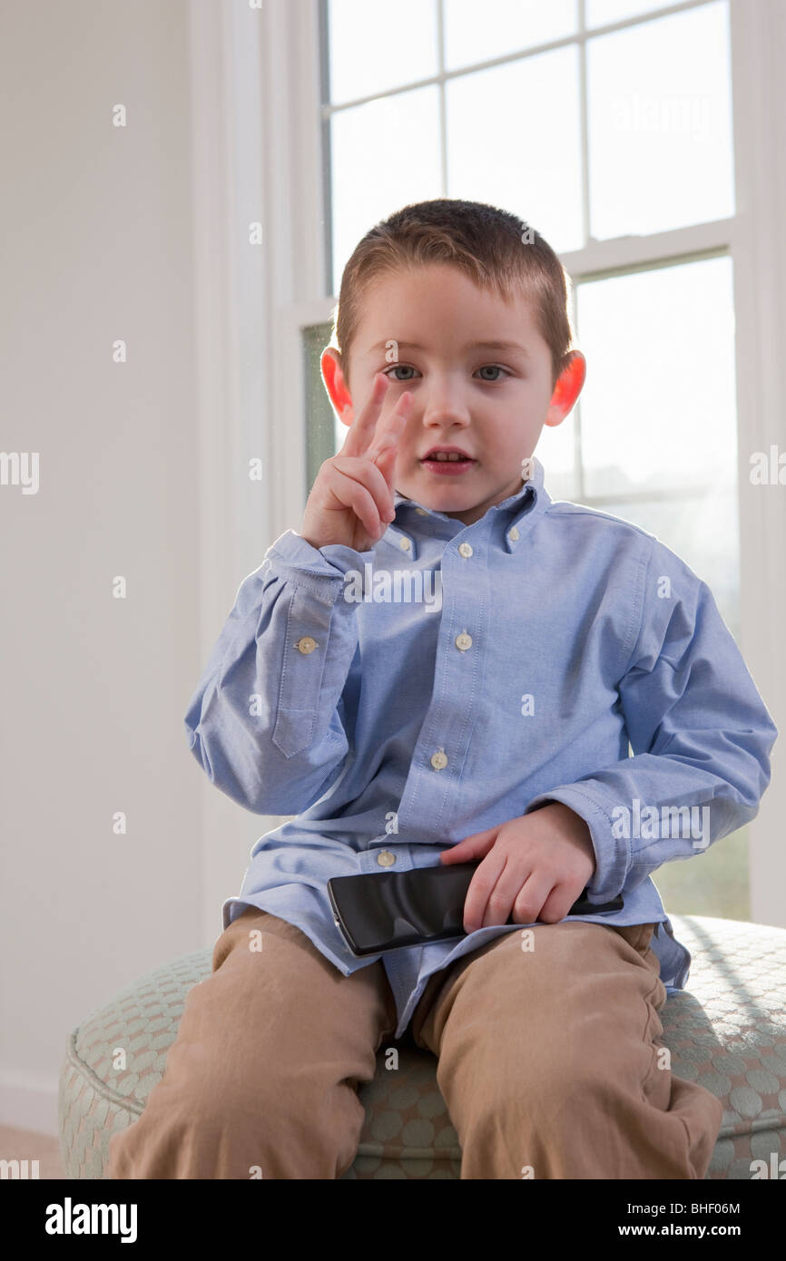 Boy signing the word 'TV' in American Sign Language Stock Photo
