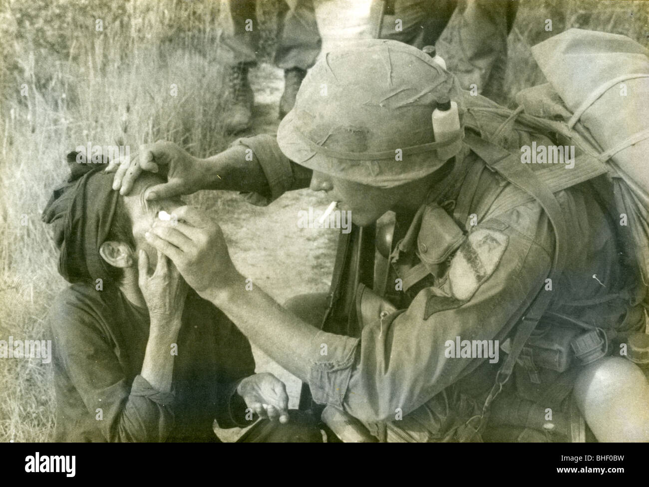 A combat medic tends to a vietnamese village woman's eye. Vietnam War
