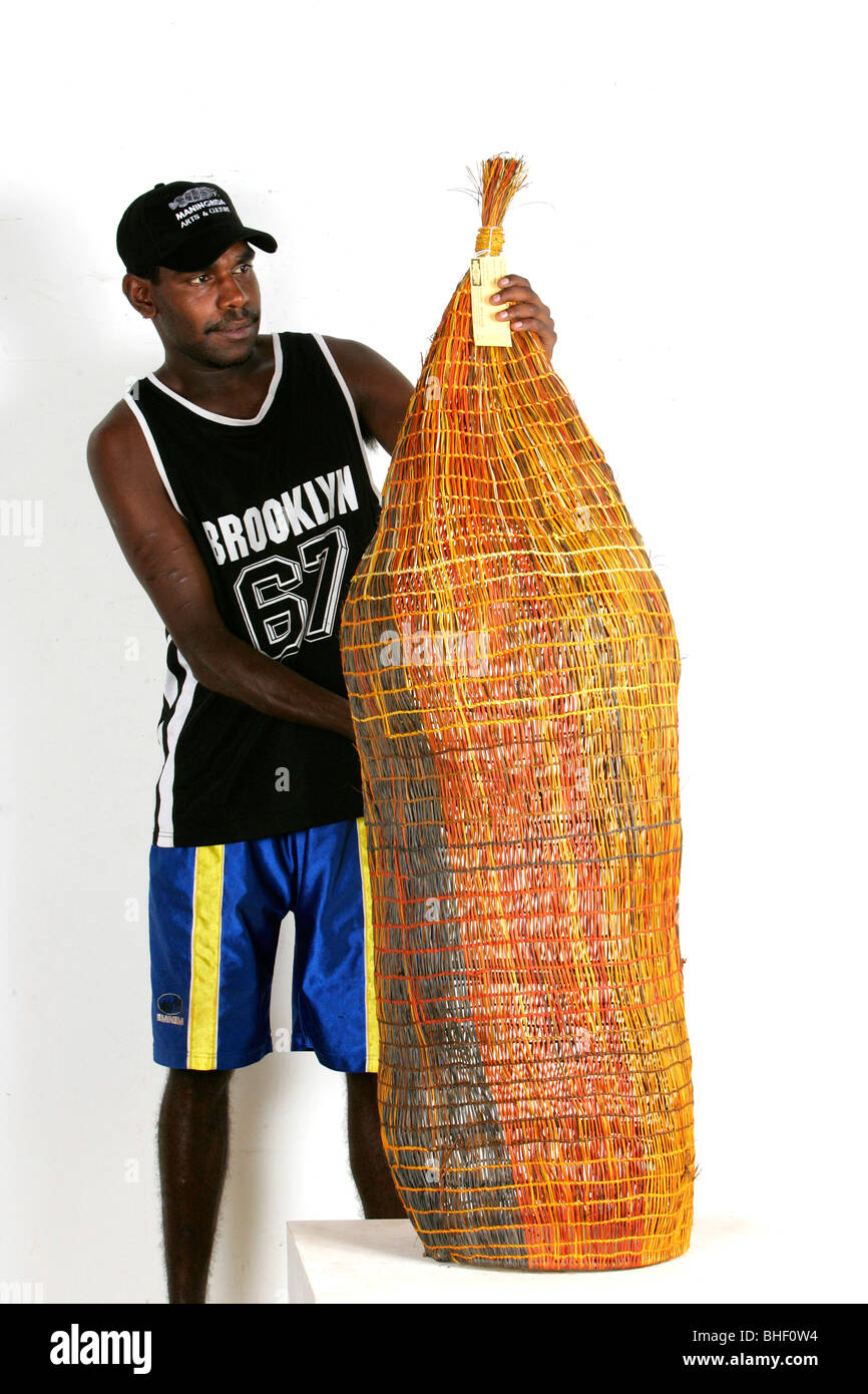 Australian aboriginal  Artist Asmond Turner-Ali with art (fish trap). Stock Photo