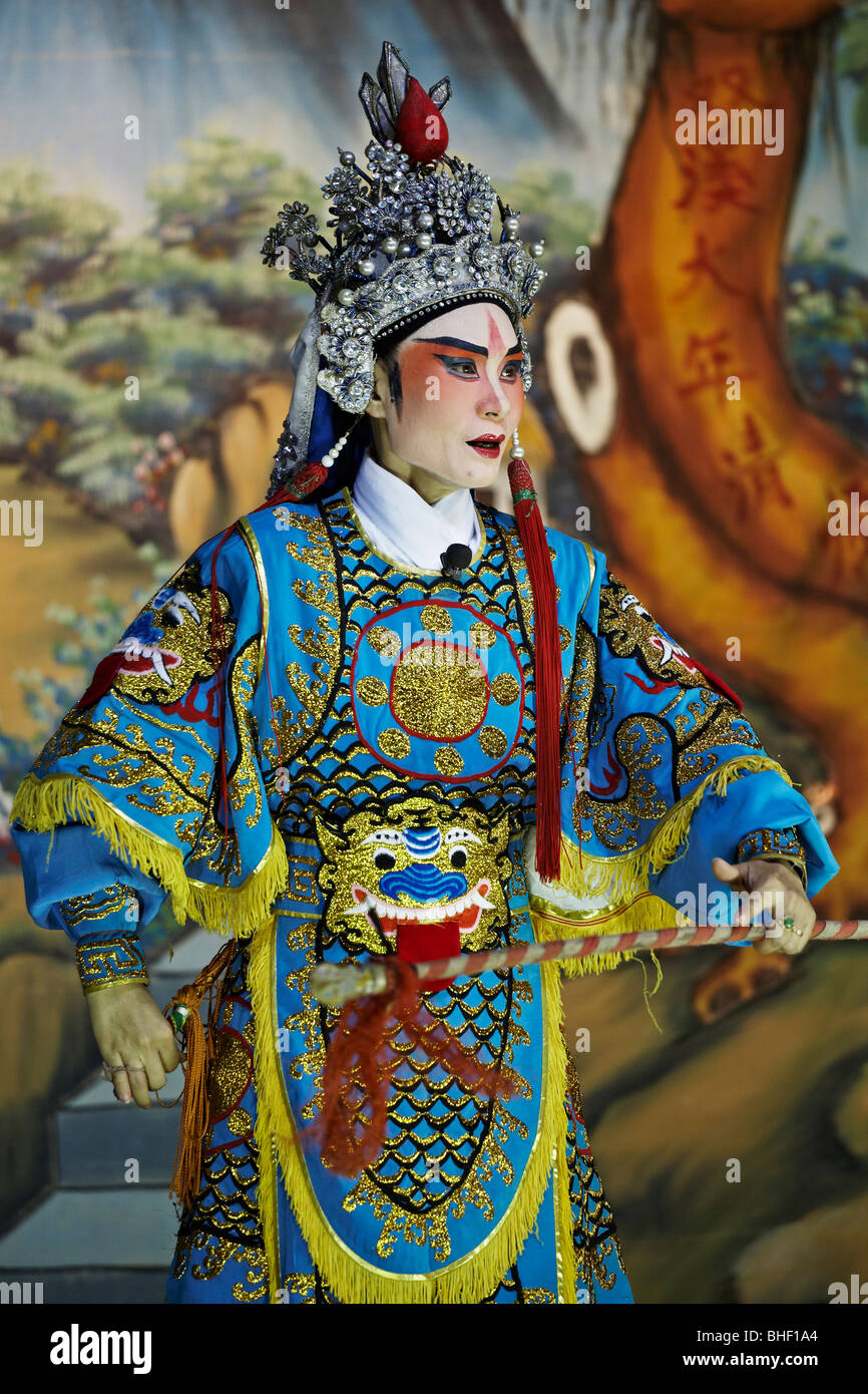 Chinese opera actor on stage in traditional colourful costume and make up. Thailand S. E. Asia Stock Photo