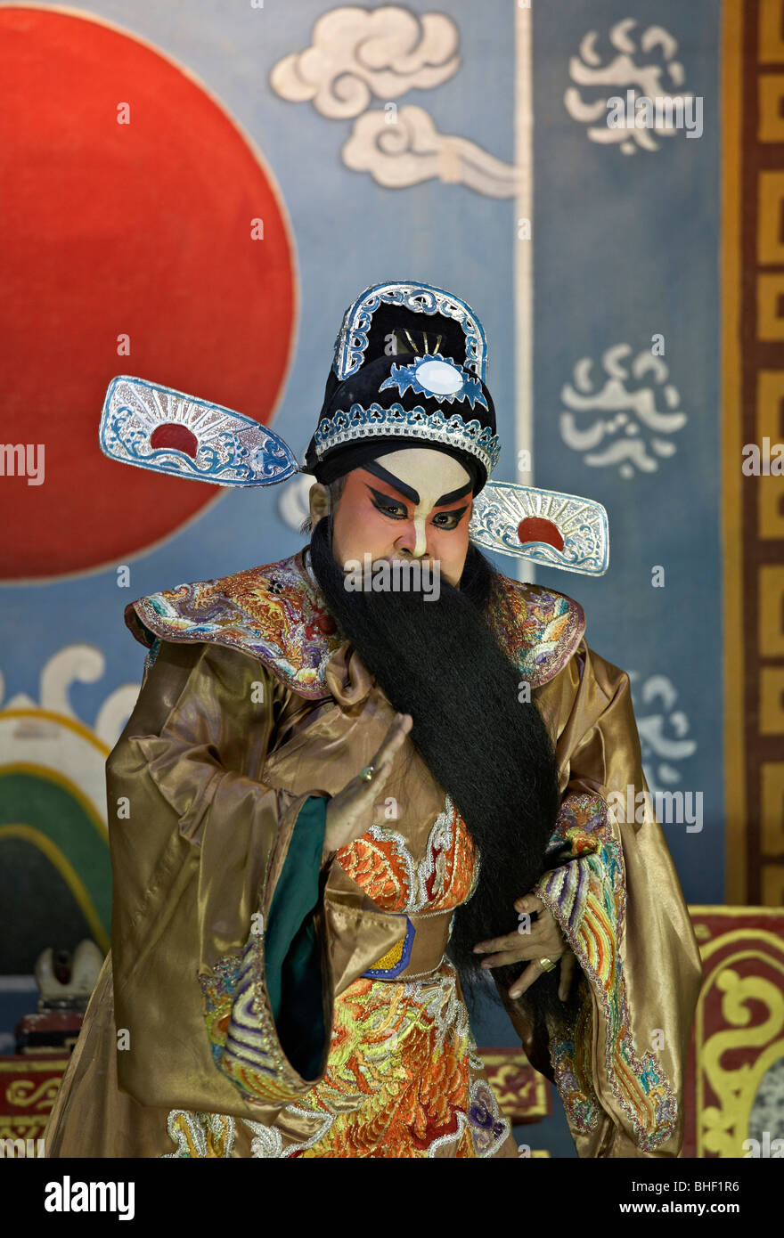 Chinese opera actor on stage in traditional colourful costume and make up. Thailand S. E. Asia Stock Photo