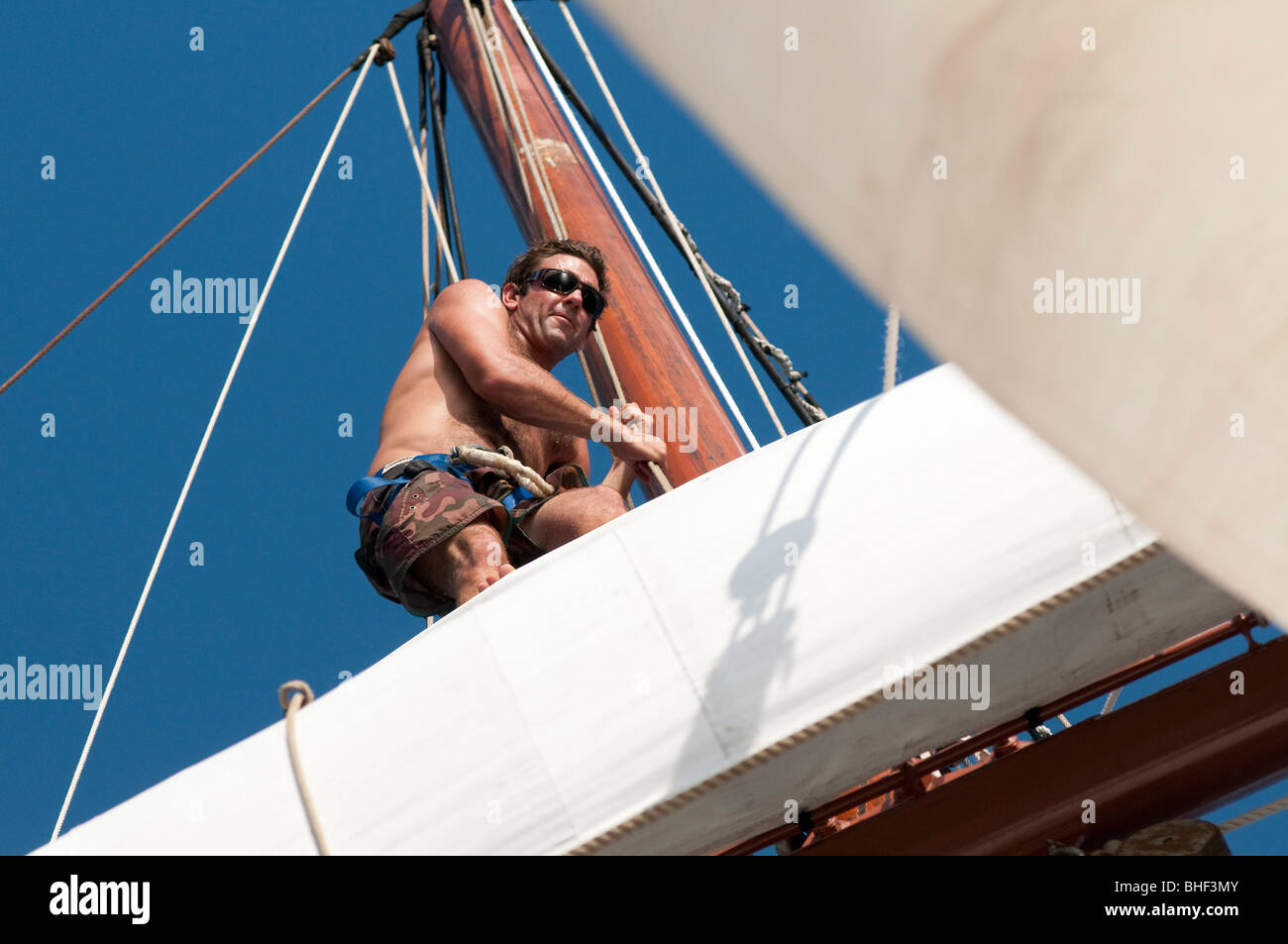 Crew members of the square-rigged tall ship Solway Lass working aloft under sail Stock Photo