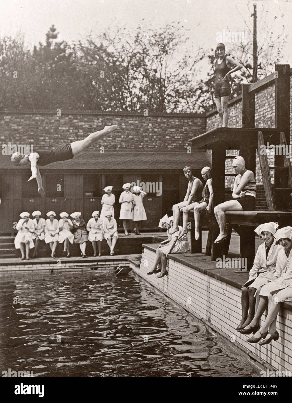 Rowntree factory workers sit around swimming pool, Yearsley baths, York,  Yorkshire, 1933. Artist: Unknown Stock Photo