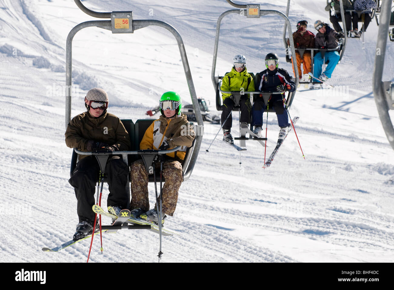 young skiers on ski chair lift, kitzbuhel, austria Stock Photo