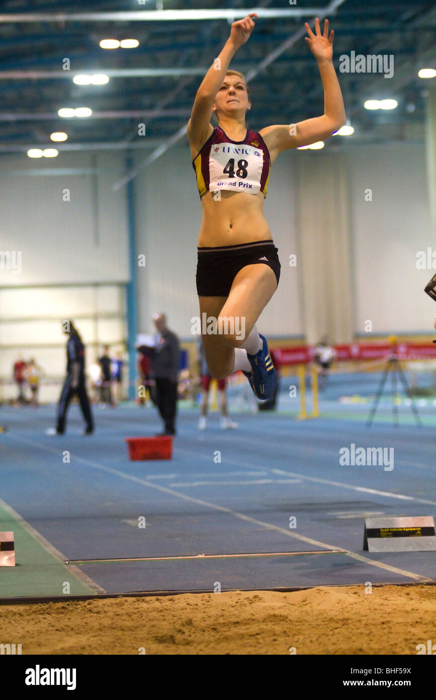 Female athlete competing in the triple jump/long jump. Stock Photo