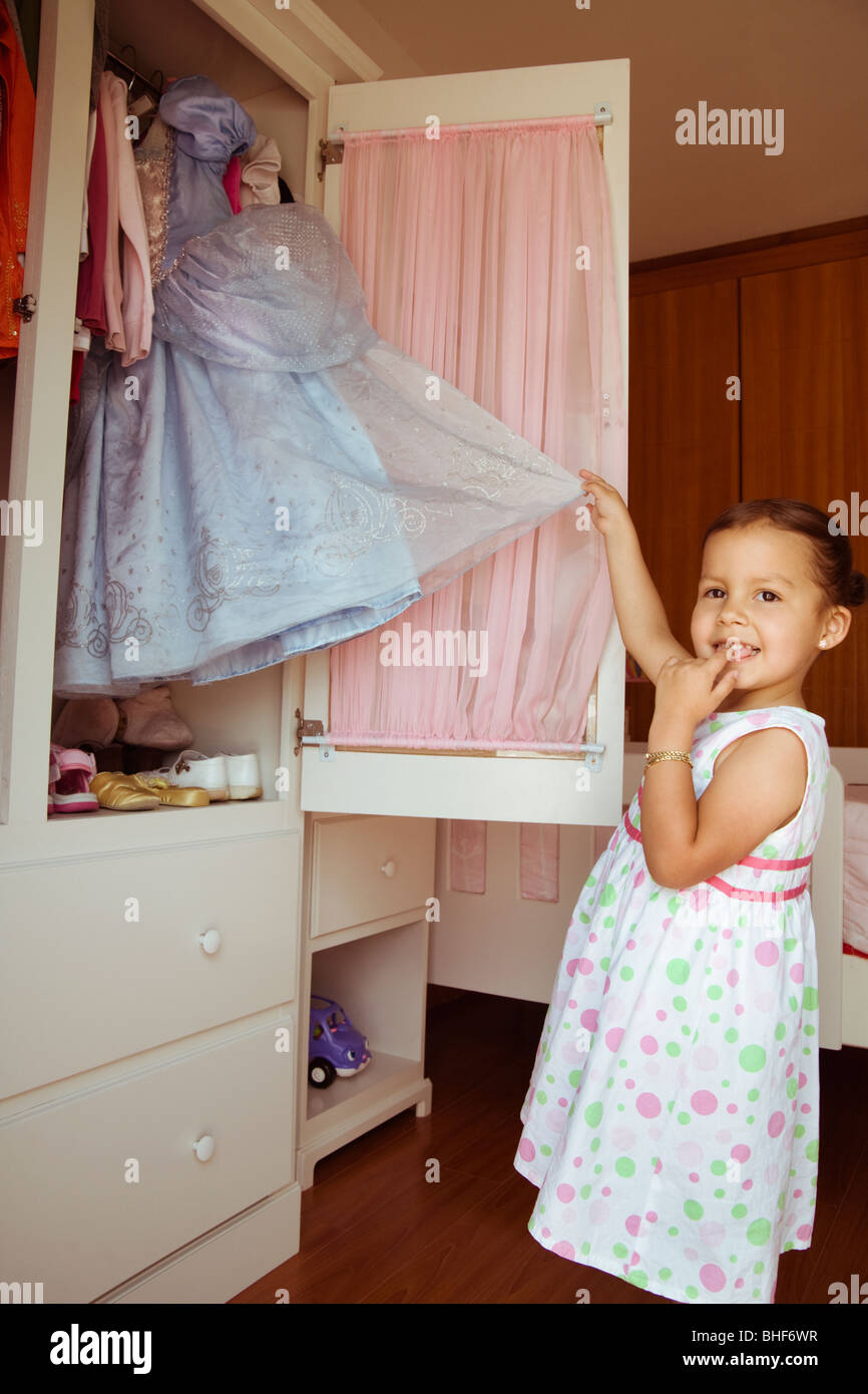 Hispanic Girl Taking Costume From Closet Stock Photo Alamy