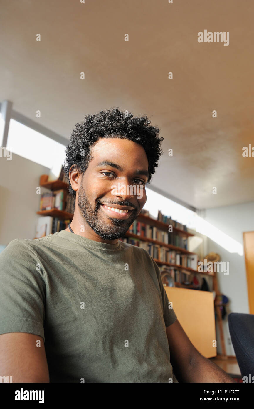 Black man smiling in living room Stock Photo - Alamy