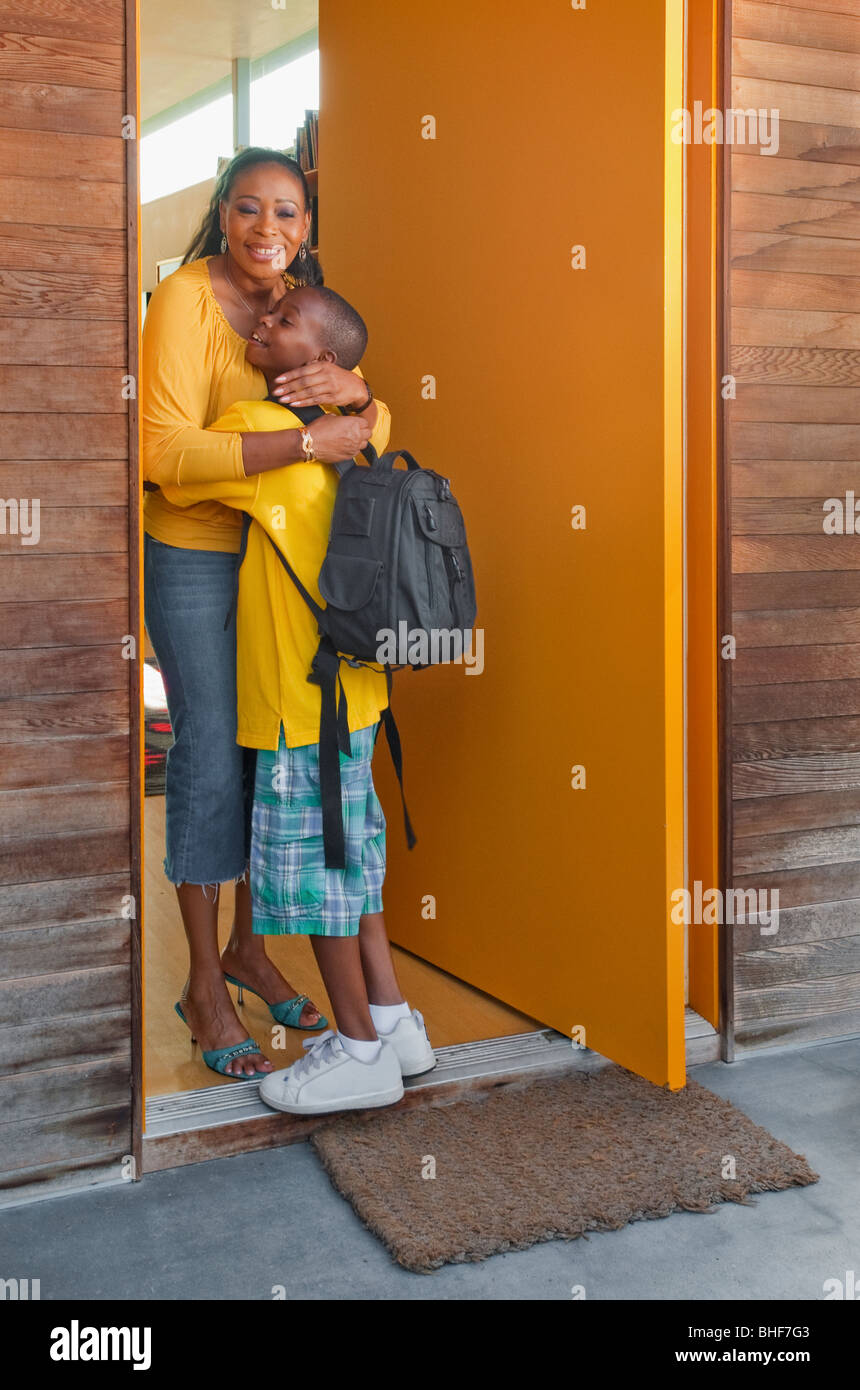 black-mother-greeting-son-at-front-door-stock-photo-alamy