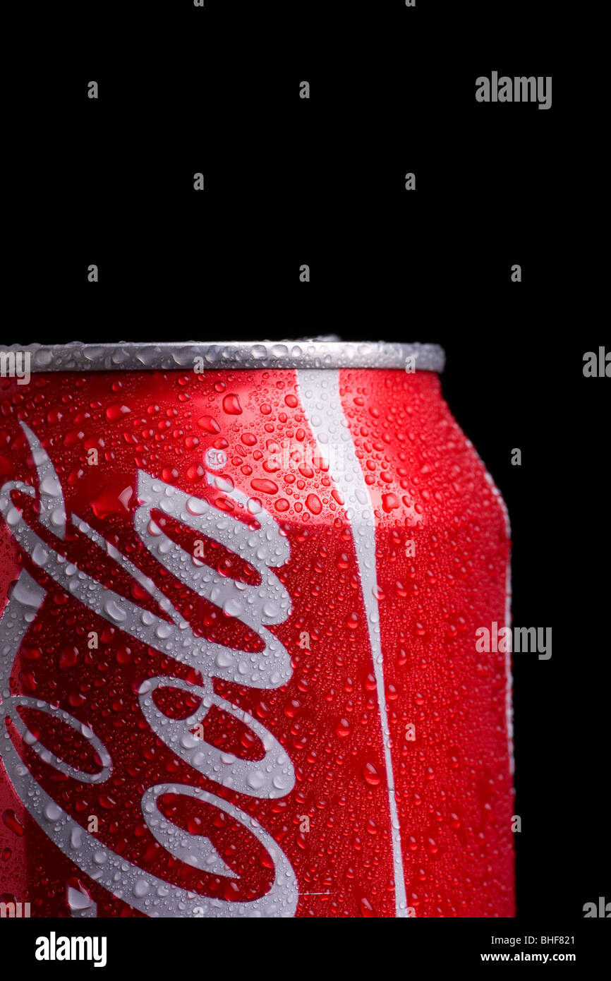 Coke can profile with beads of condensate water on a black background ...