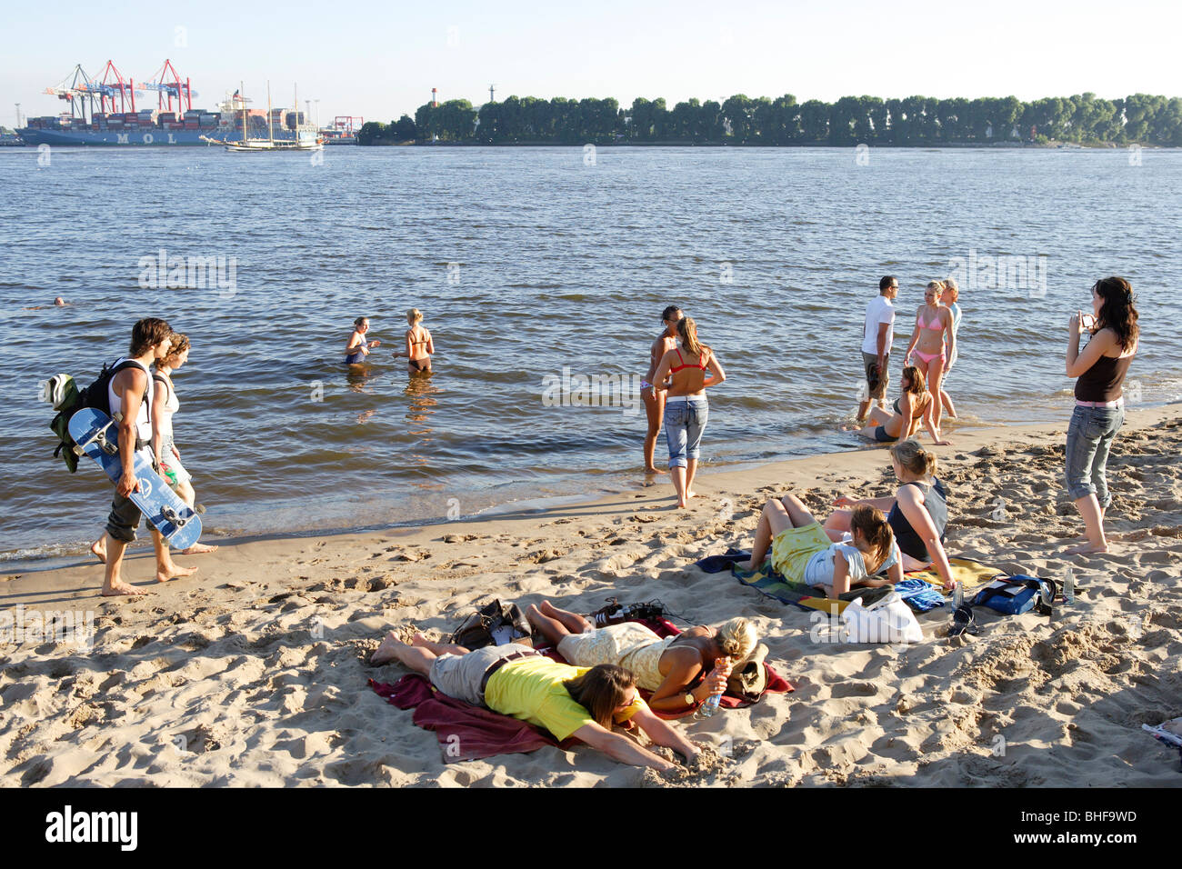Young people at sandy beach of river Elbe, Oevelgoenne, Hamburg, Germany Stock Photo