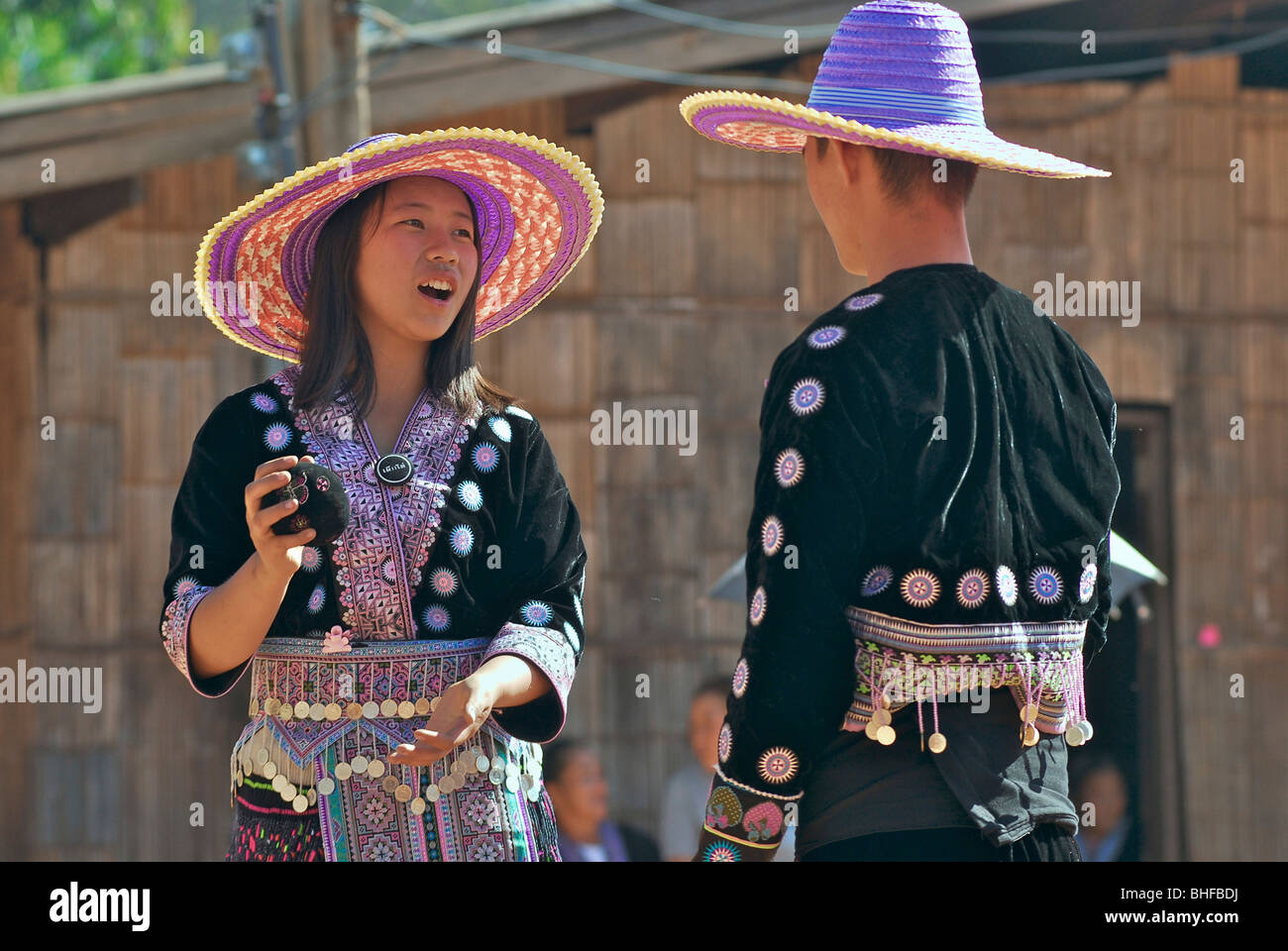 Hmong woman and man with ball dressed in traditional costume, Mae Rim Valley, Hmong village,  Province Chiang Mai, Thailand, Asi Stock Photo