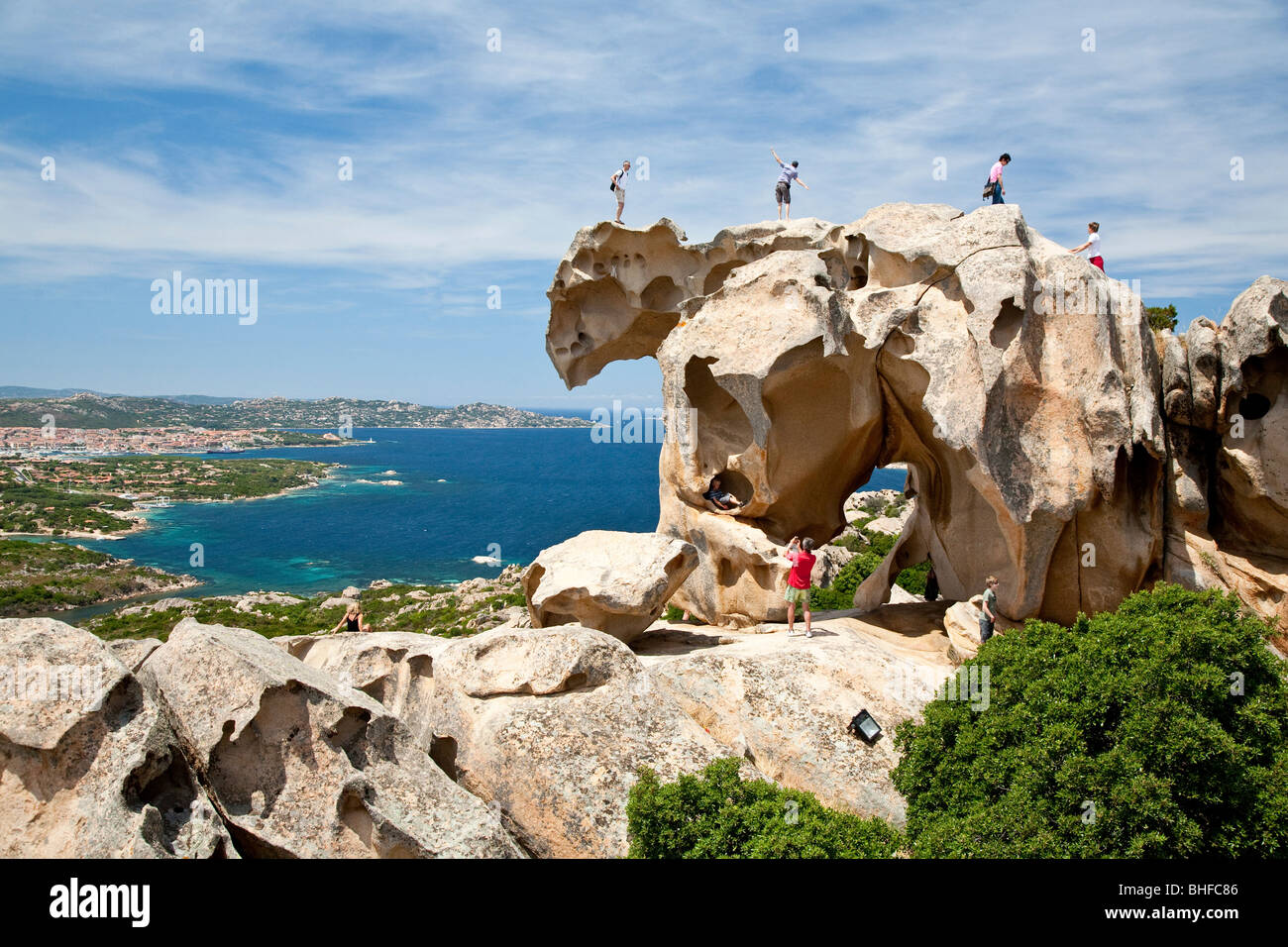 Tourists on a bear shaped rock formation, Capo d'Orso, Palau, Sardinia, Italy, Europe Stock Photo