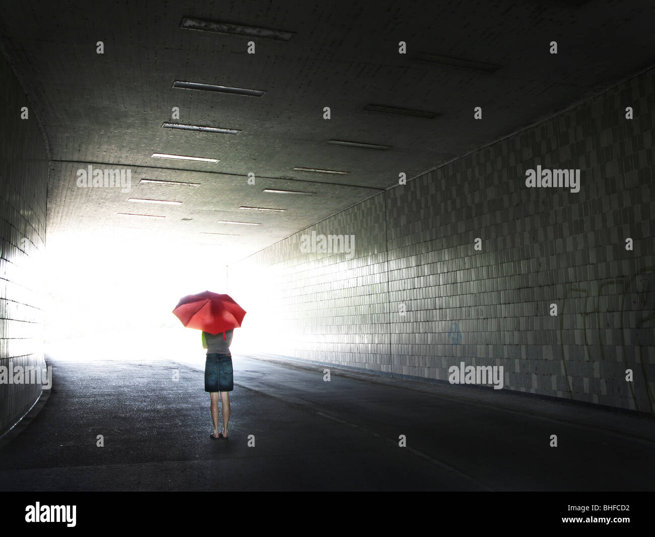 Woman with red umbrella in a subway, Mannheim, Baden-Wurttemberg, Germany Stock Photo